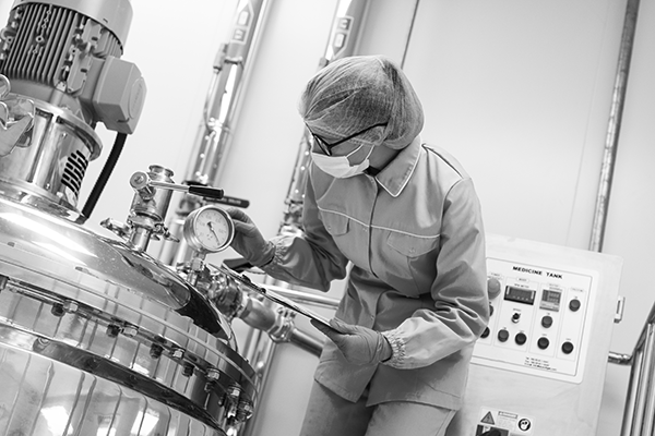 Female scientist checking a compressor tank