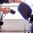 EV charger being plugged into a blue car