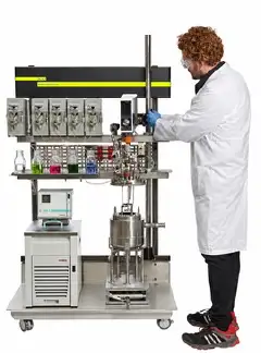 Scientist operating a multi-vessel AutoLAB automated reactor system