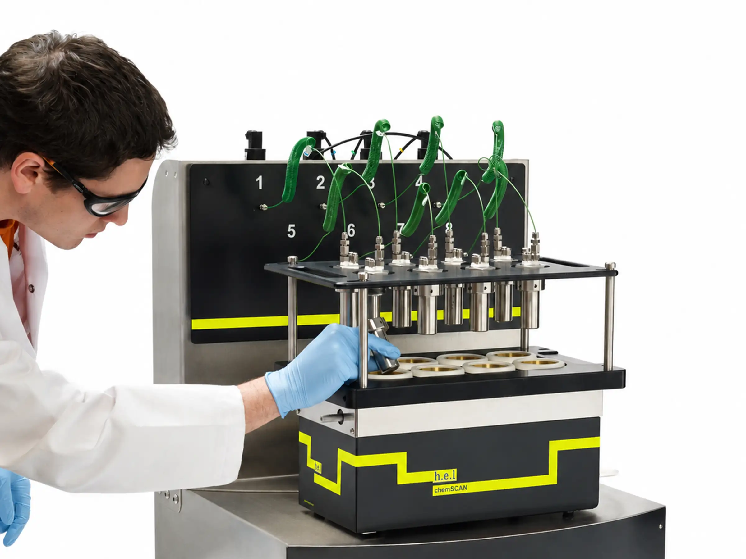 Chemist loading reactor vessels into a H.E.L ChemSCAN parallel high-pressure reactor system