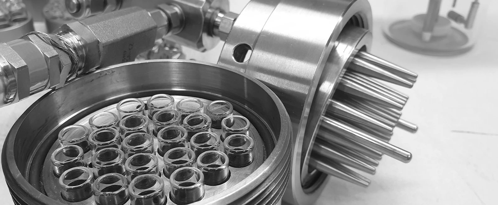 Close view of 24 vials in their circular pattern beside the cold fingers